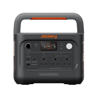 Jackery portable power station Explorer 1000 Plus v2 in dark gray with orange accents, featuring a built-in handle, digital display screen, multiple AC outlets, and various USB-C and USB-A ports, shown on a solid white background.