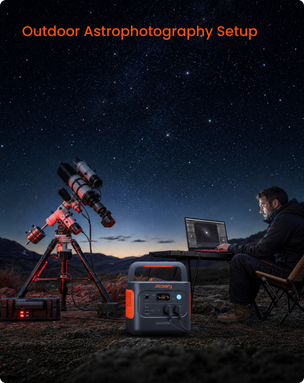 Outdoor astrophotography setup at night with a mounted telescope on a tripod, a person sitting by a laptop, and a Jackery portable power station in the foreground under a starry sky. Orange text at the top reads 'Outdoor Astrophotography Setup'.