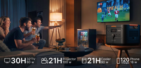 Jackery backup power generator running a television and mini fridge for a summer garden party and football match viewing night, showing a home energy storage solution.